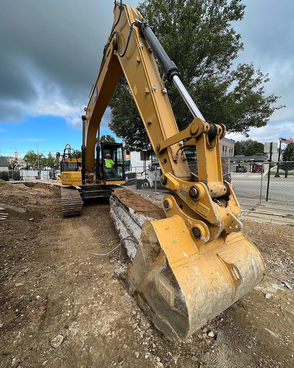A Large Yellow Excavator is Sitting on Top of a Dirt Field | Wooster, OH | Bogner Construction Company