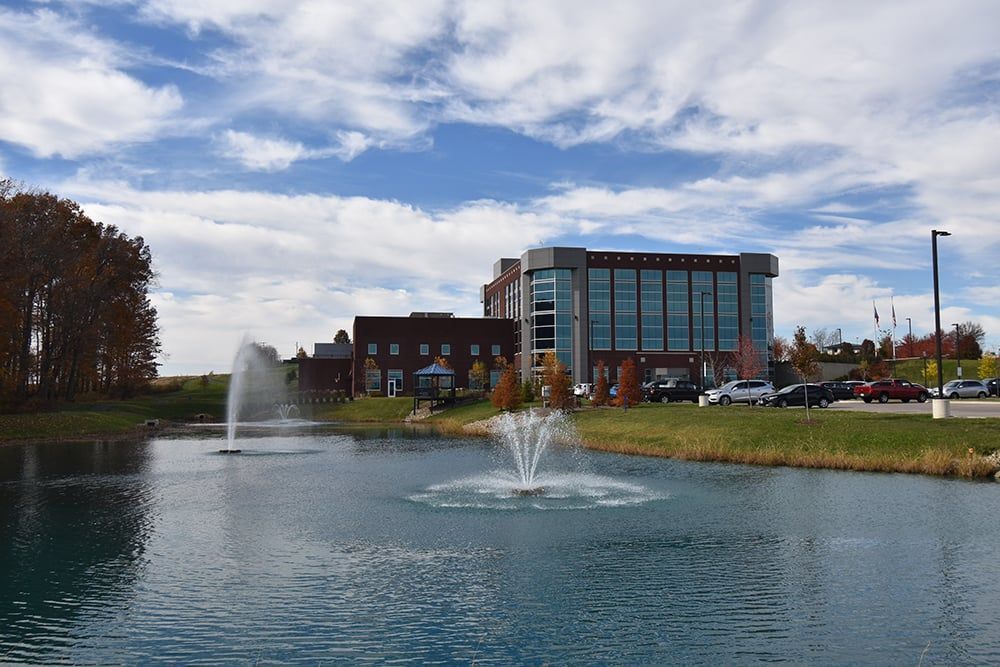 A Pond with a Fountain in the Middle of it in Front of a Building | Wooster, OH | Bogner Construction Company