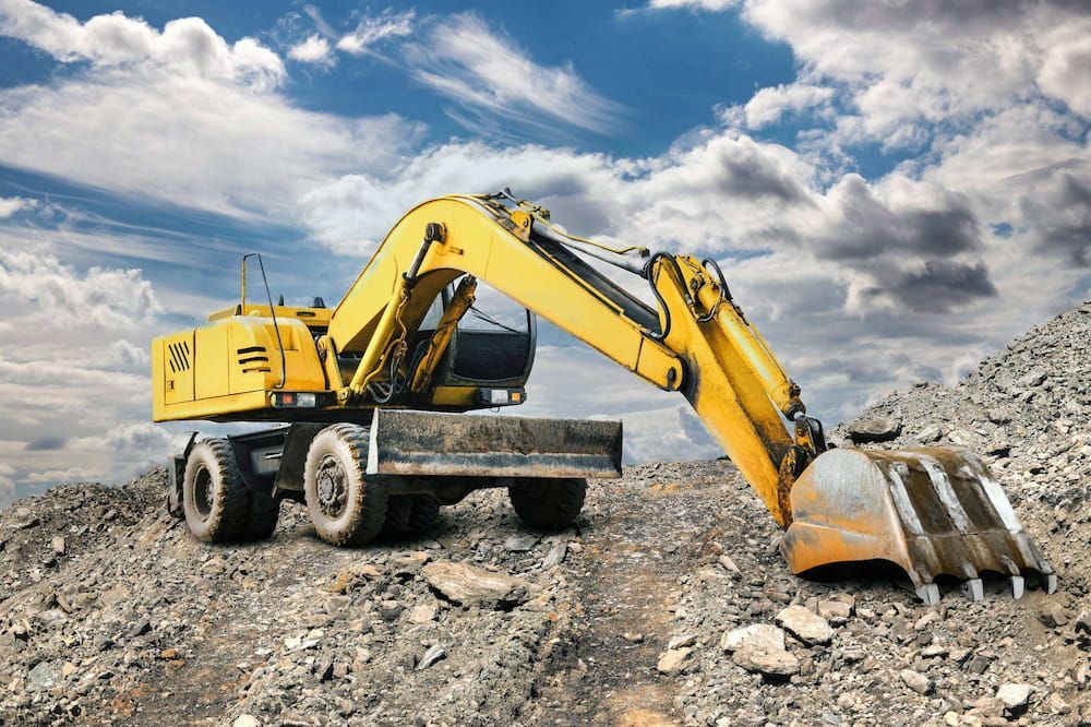 Yellow Excavator on a Rocky Construction Site — Dentmaster Refinishing In Bungalow, QLD