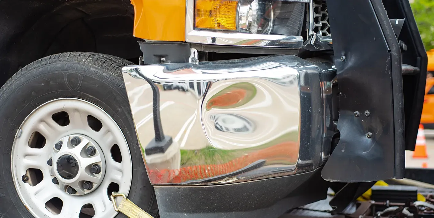 A Damaged Front Bumper on a Truck— Dentmaster Refinishing In Bungalow, QLD