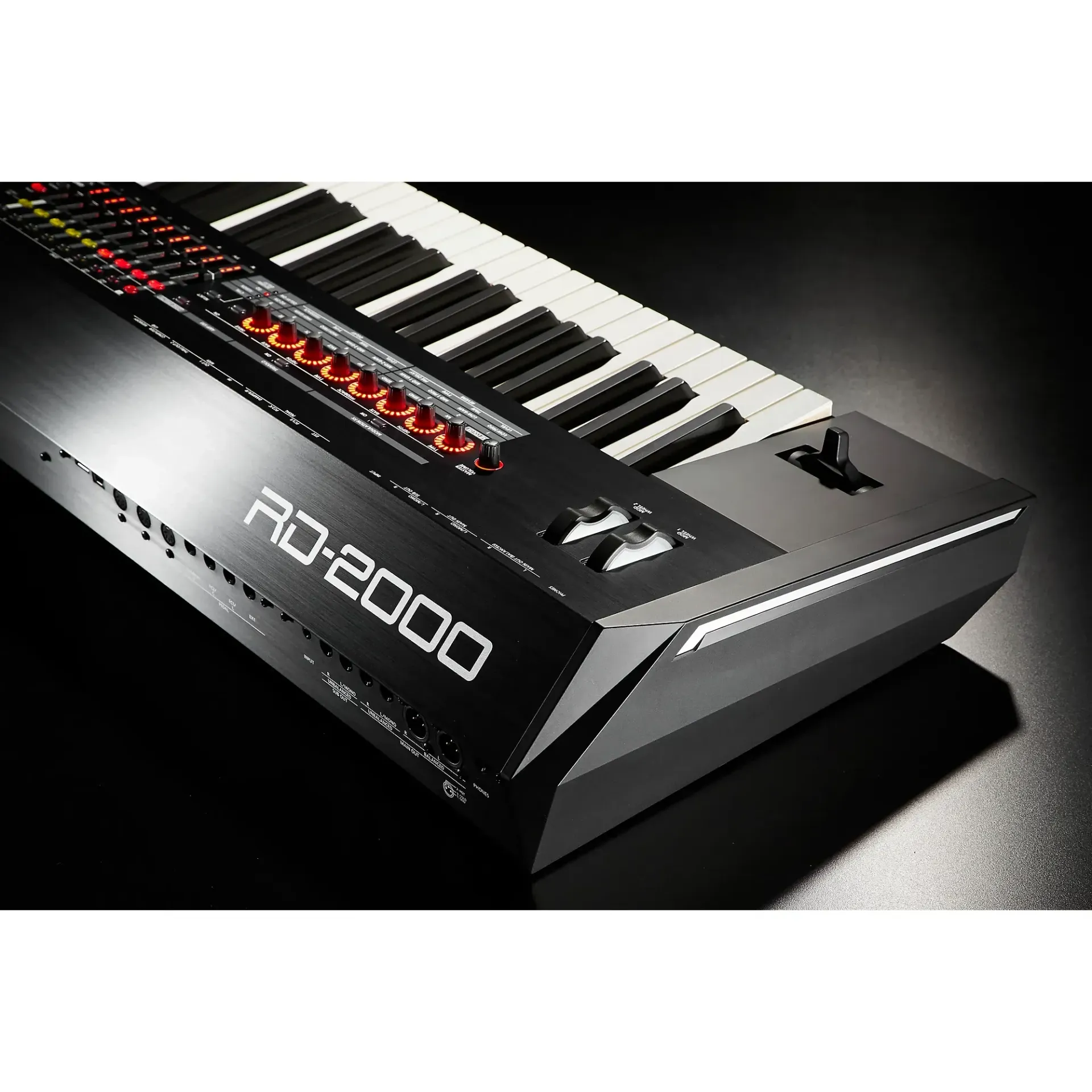 Black Roland RD-2000 digital piano keyboard on a dark surface.