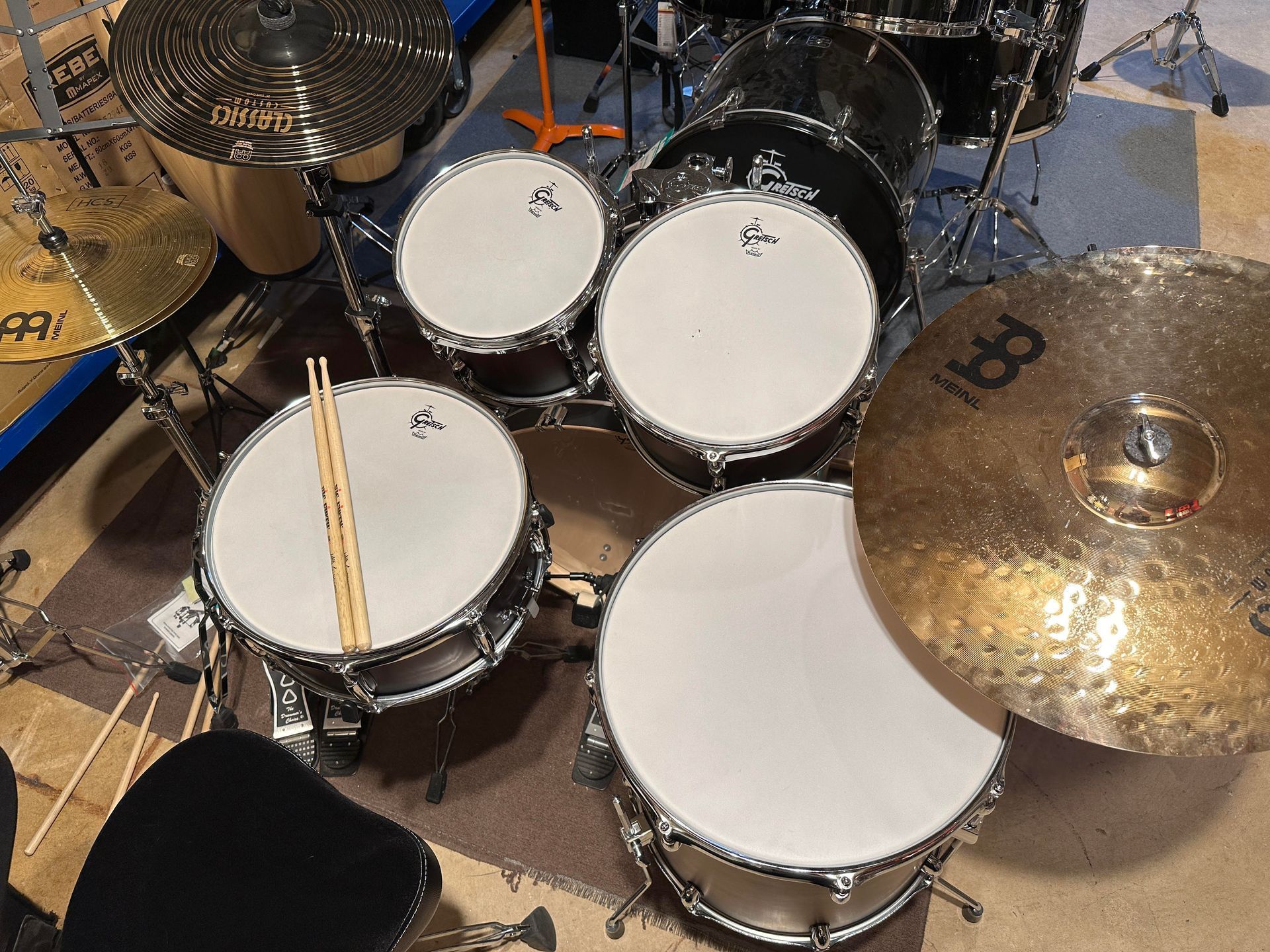 Drum set with cymbals and drumsticks, ready to play.