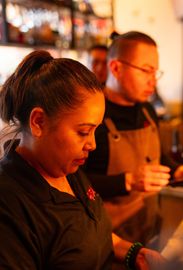 A man and a woman are working in a restaurant