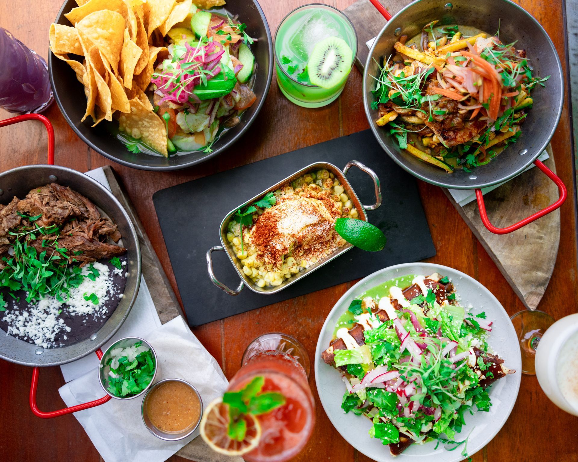 A table topped with plates of food and drinks.