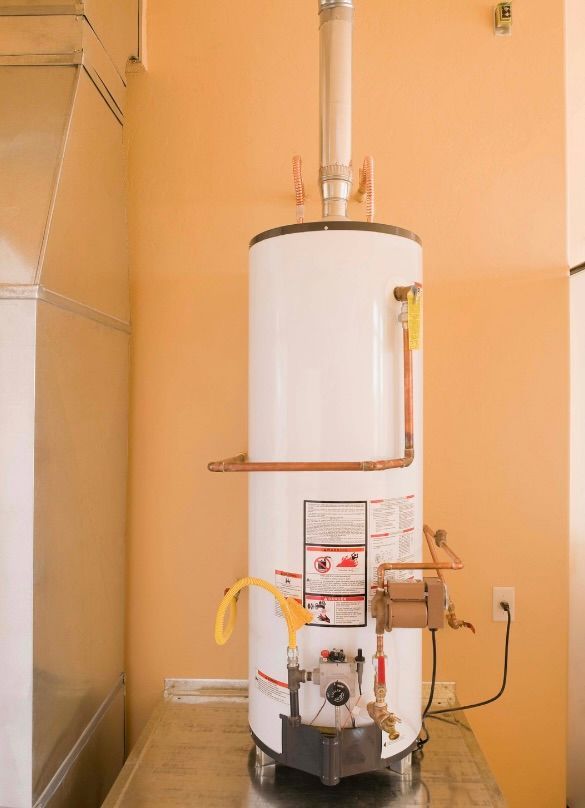 A man is fixing a water heater in a bathroom.