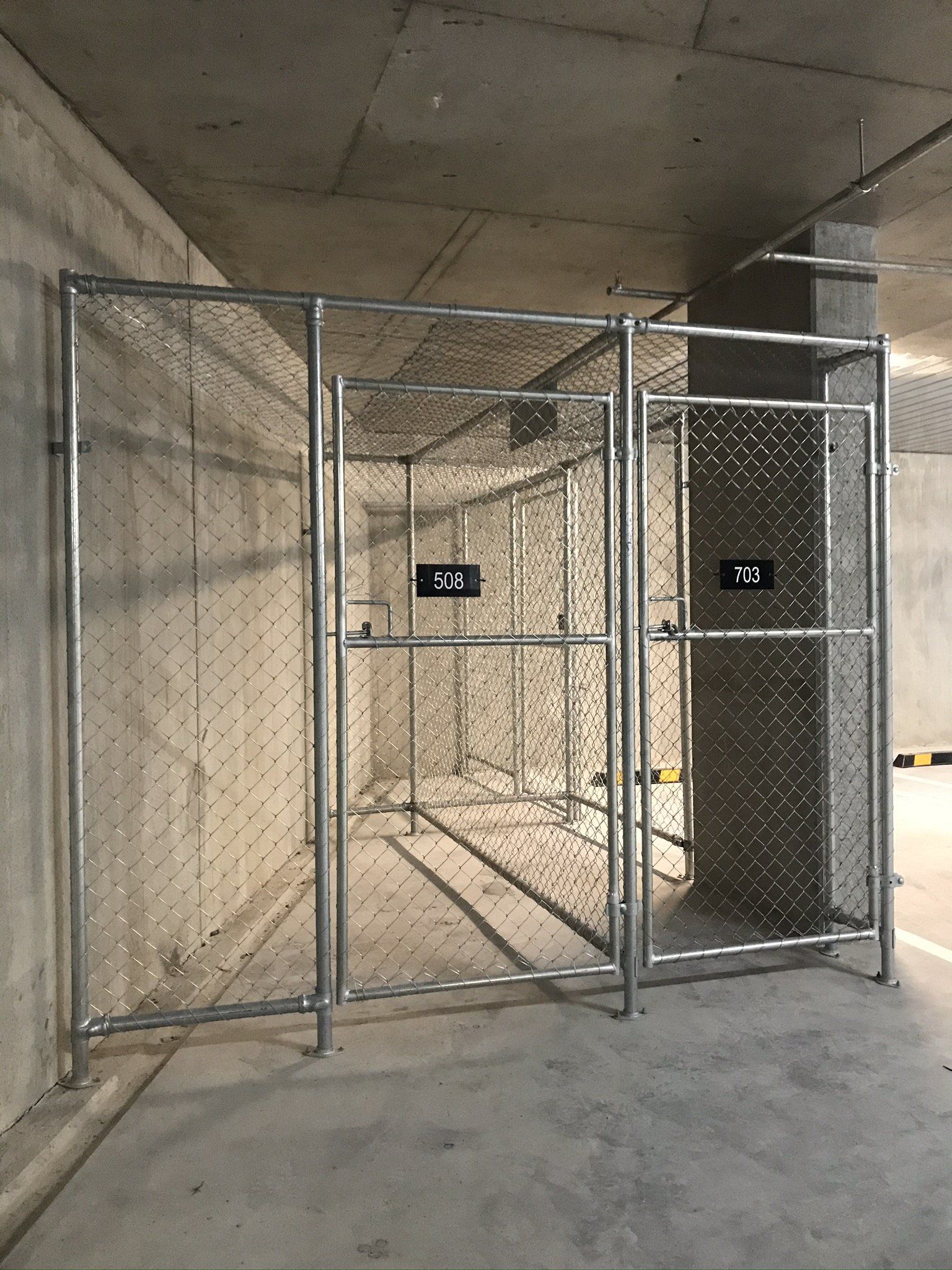 Chain mesh storage cages in a basement corner