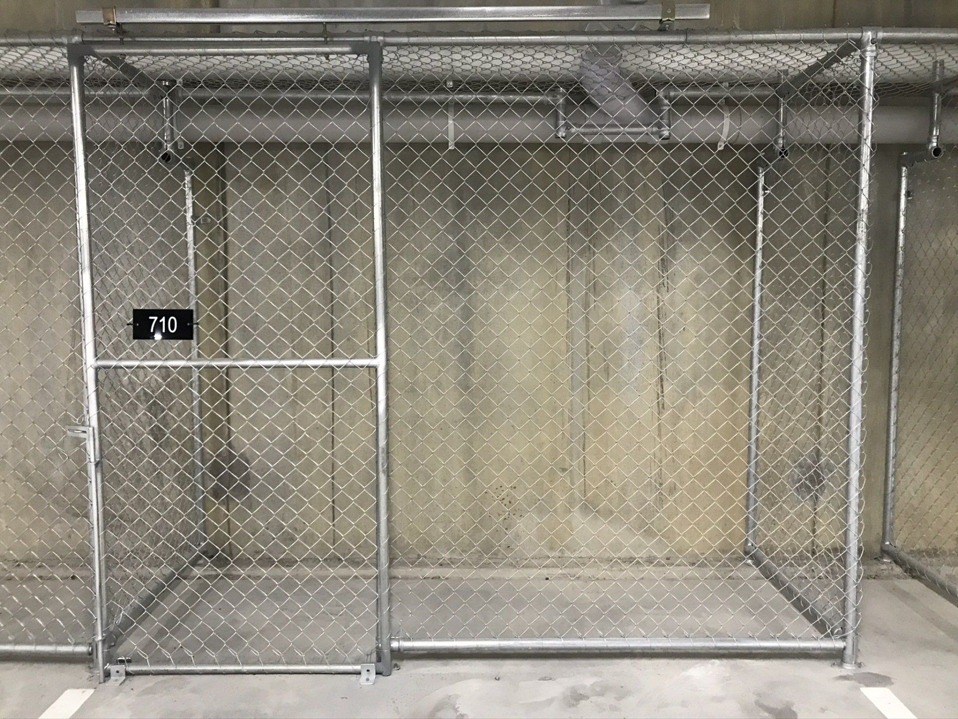 chain mesh storage cage with a sliding front entry gate