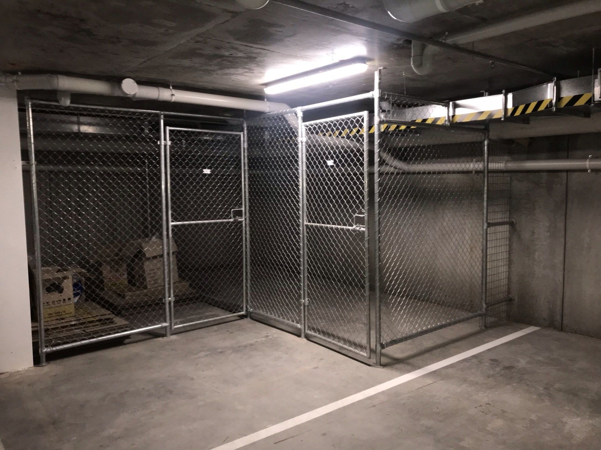 Chain mesh storage cages in a basement carpark