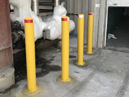 Larger yellow bollards in a basement carpark