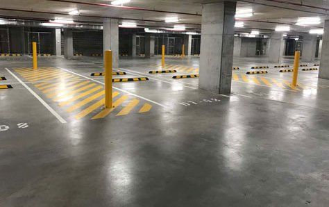 Yellow bollard in a basement carpark shared zone