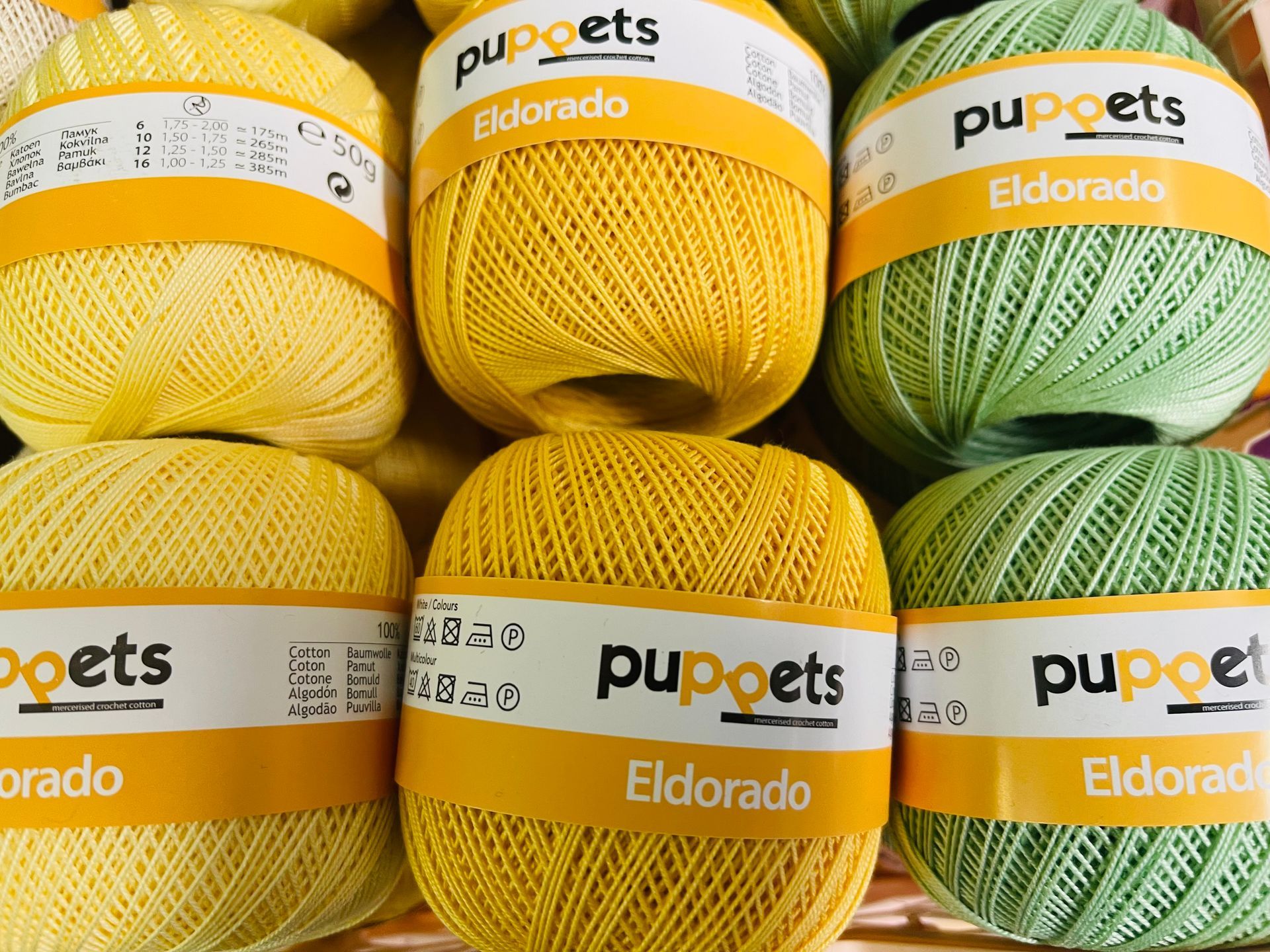 A bunch of balls of yarn are sitting on top of each other.