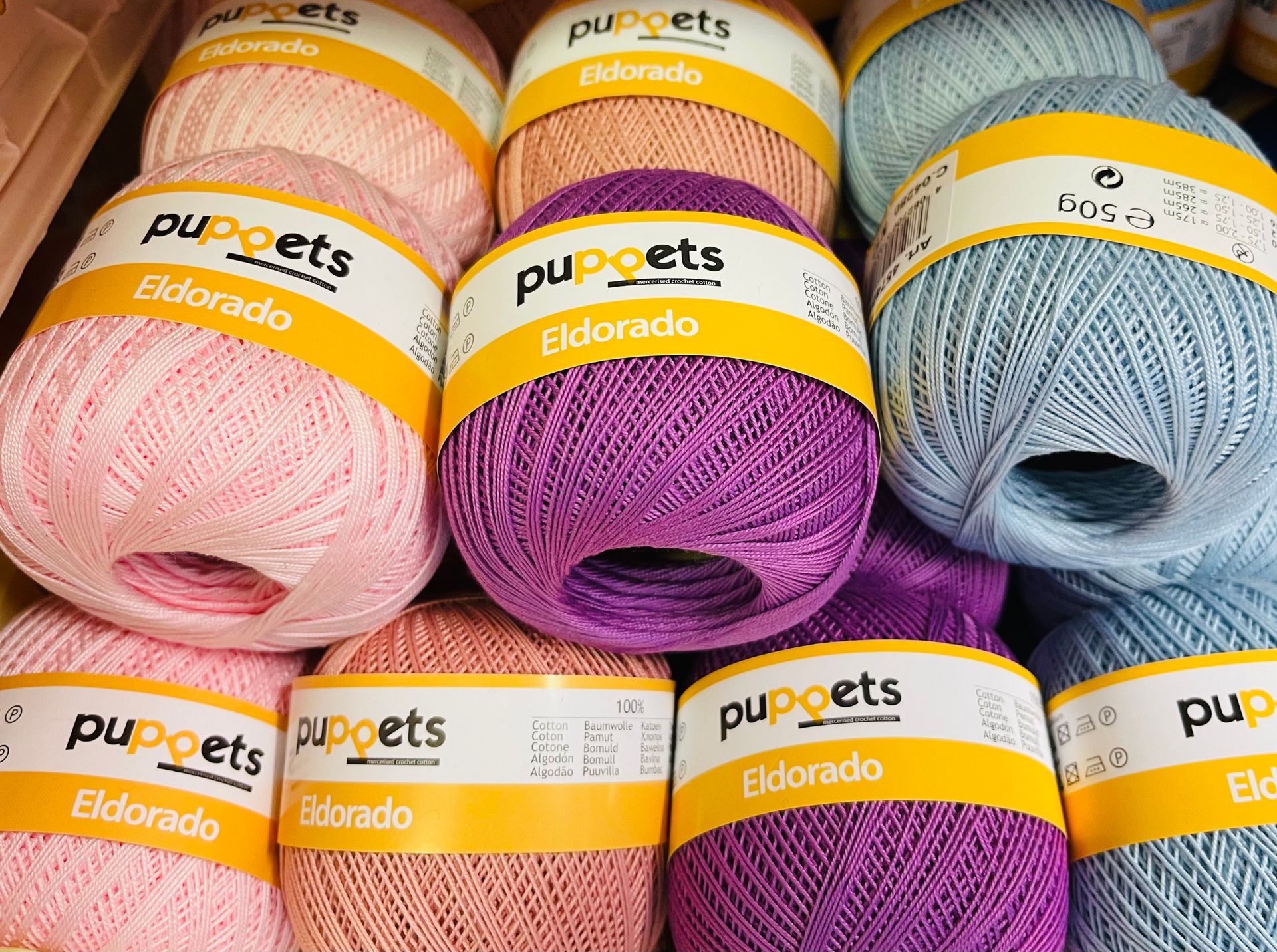 A bunch of balls of yarn are stacked on top of each other.