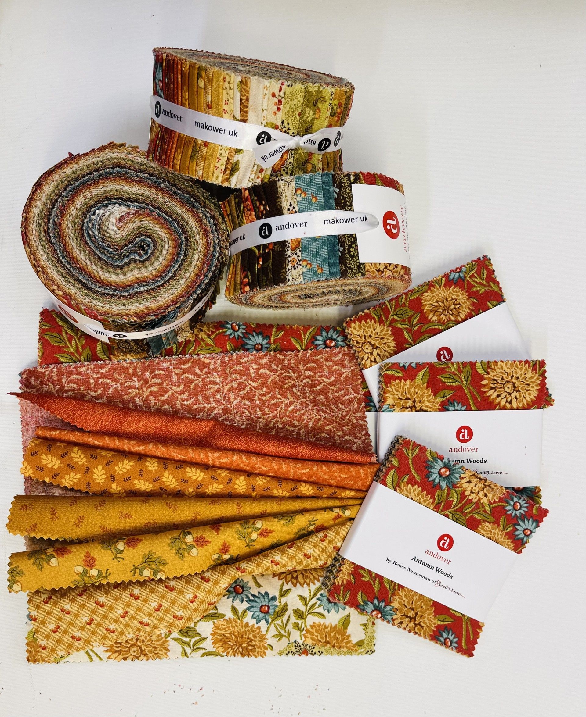 Several rolls of fabric are stacked on top of each other