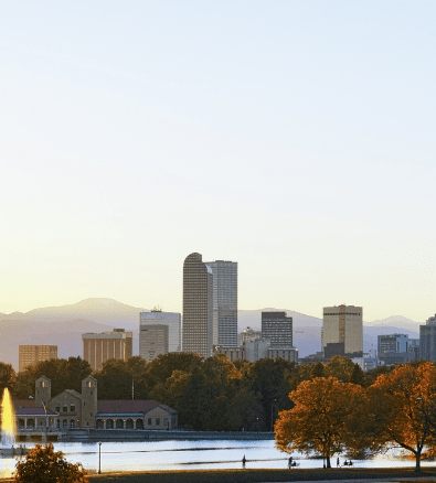 A city skyline with a fountain in the foreground