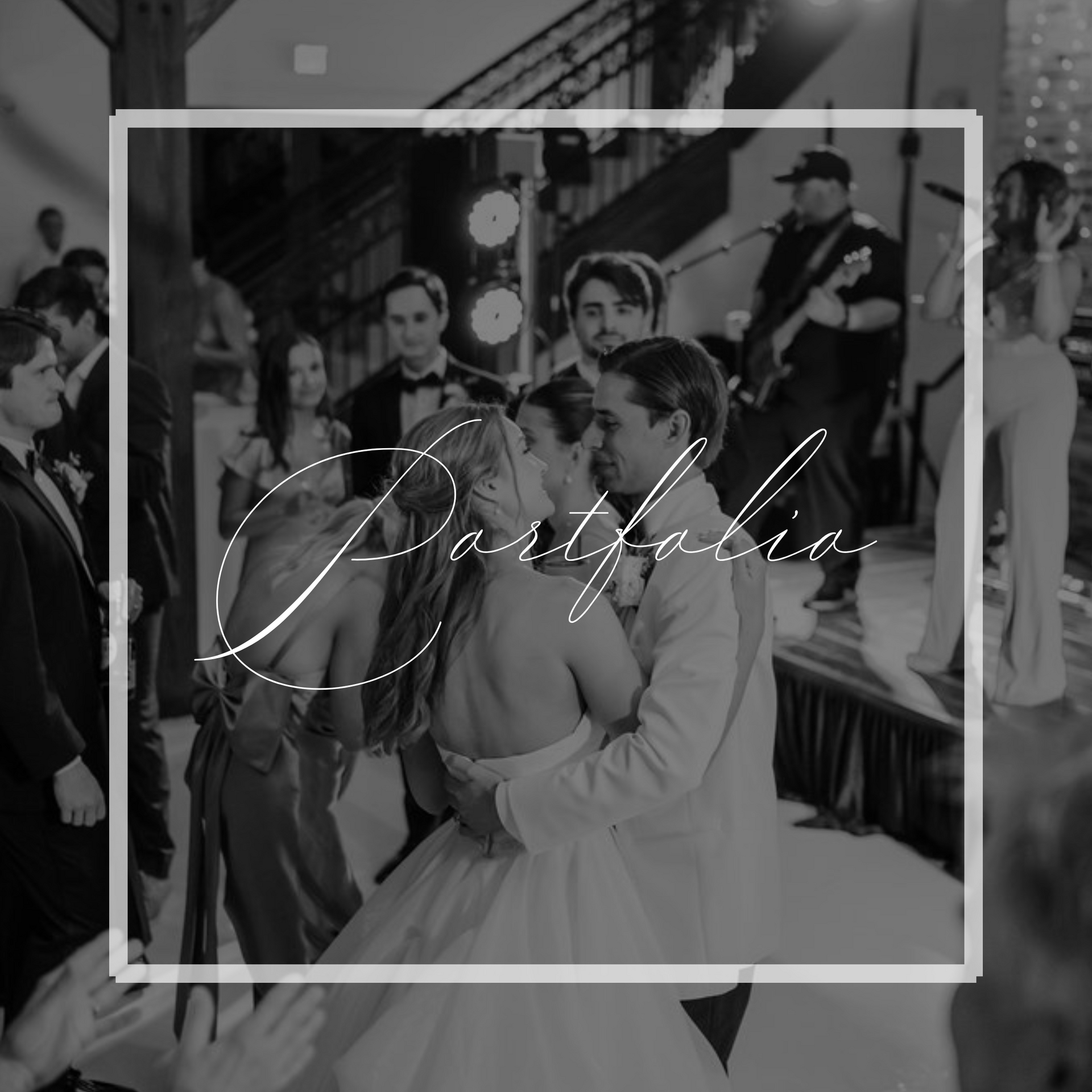 Couple dancing at a wedding reception with a live band. Guests surround them. Black and white.