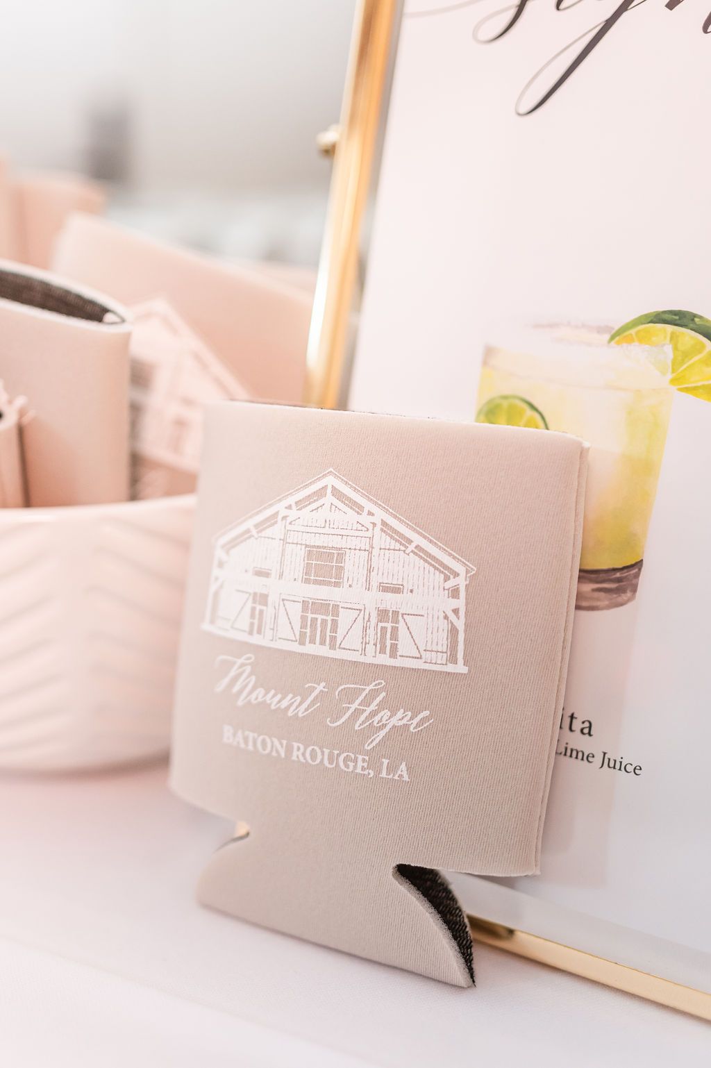 Tan drink koozie with white barn illustration and text: 