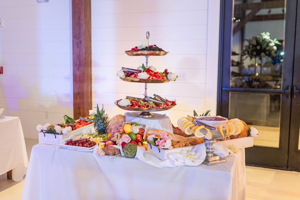 Buffet with a tiered platter of appetizers and various charcuterie.