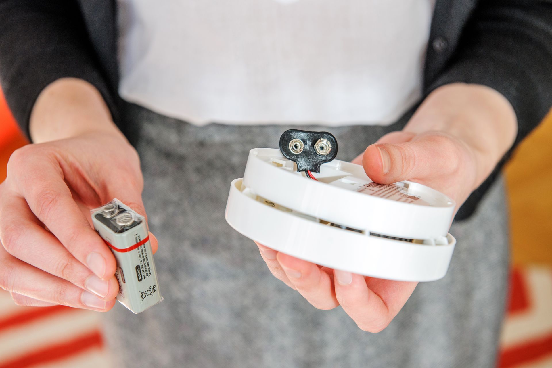 Replacing a faulty smoke alarm in a Sunshine Coast home for safety compliance.