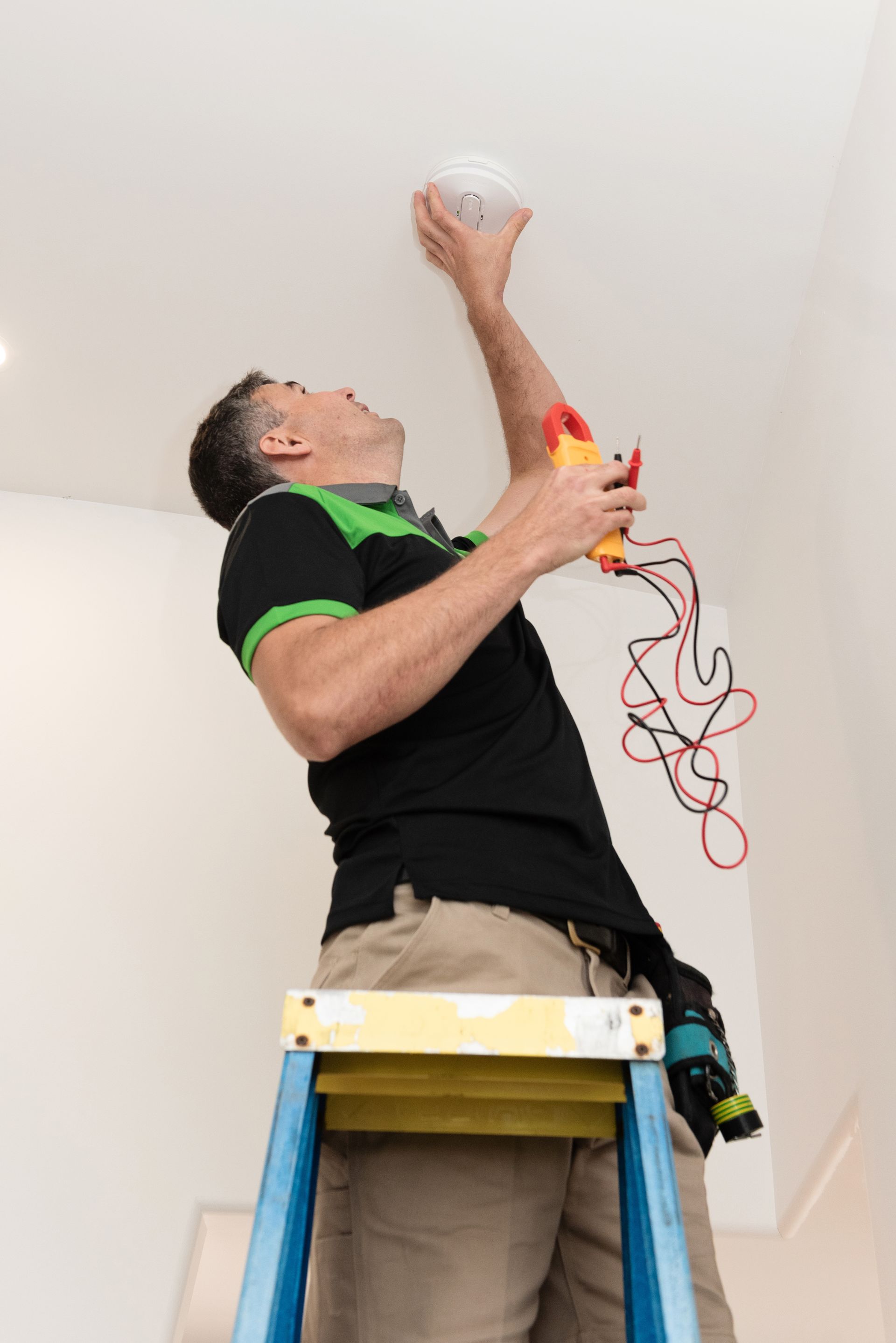 Electrician Testing Smoke Alarm