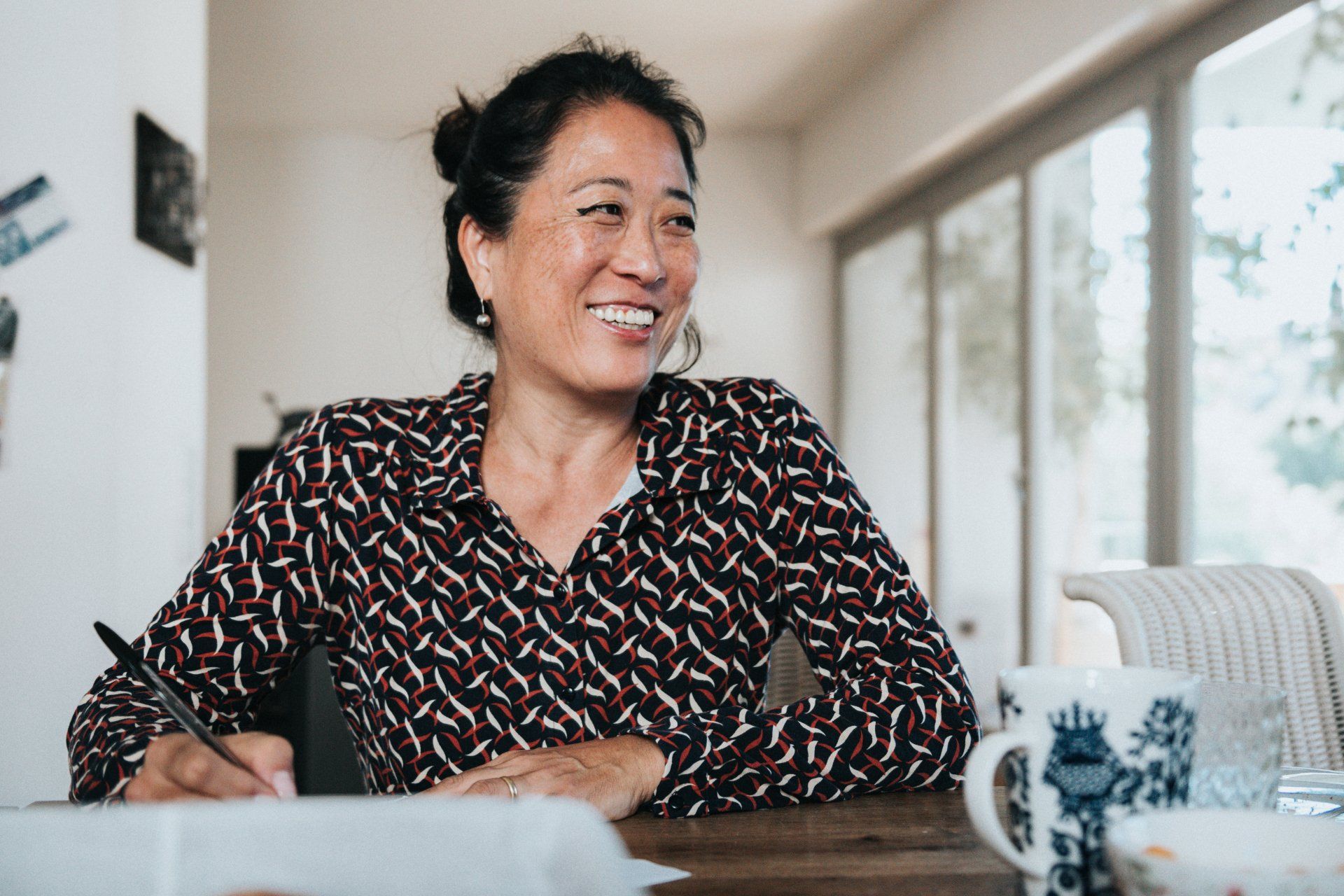 smiling woman at desk with new crowns