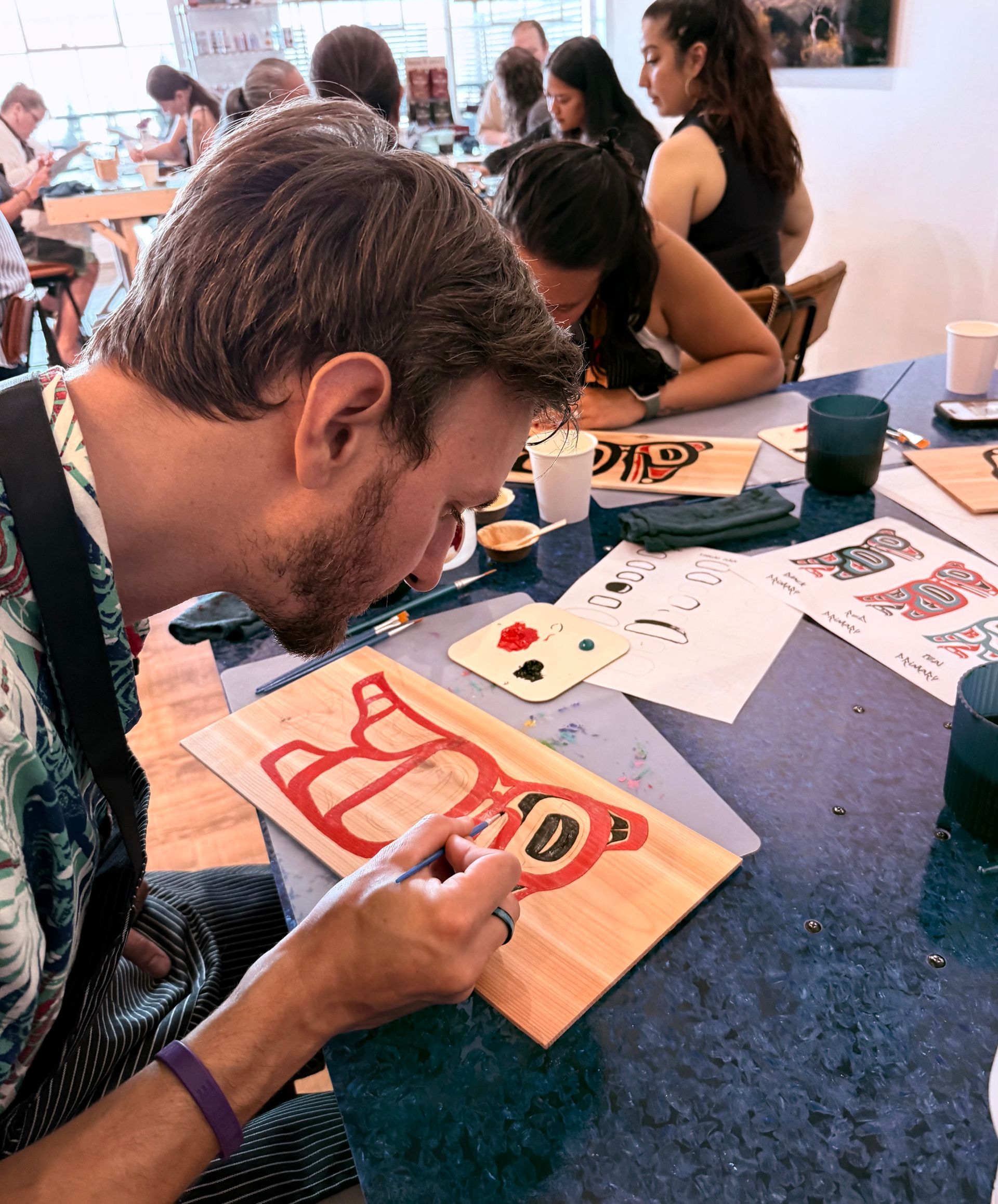 a man painting on a board