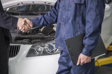 mechanic shaking hands with customer