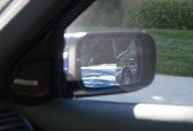A close up of a side view mirror of a car.