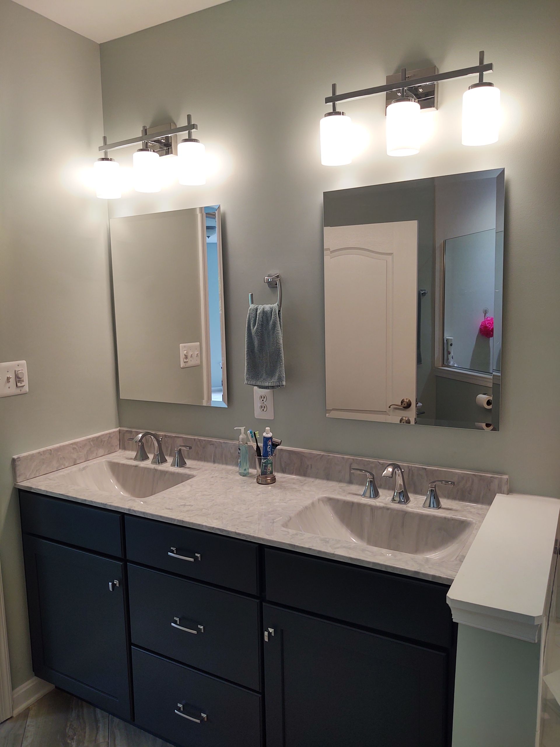 A bathroom with two sinks and two mirrors.