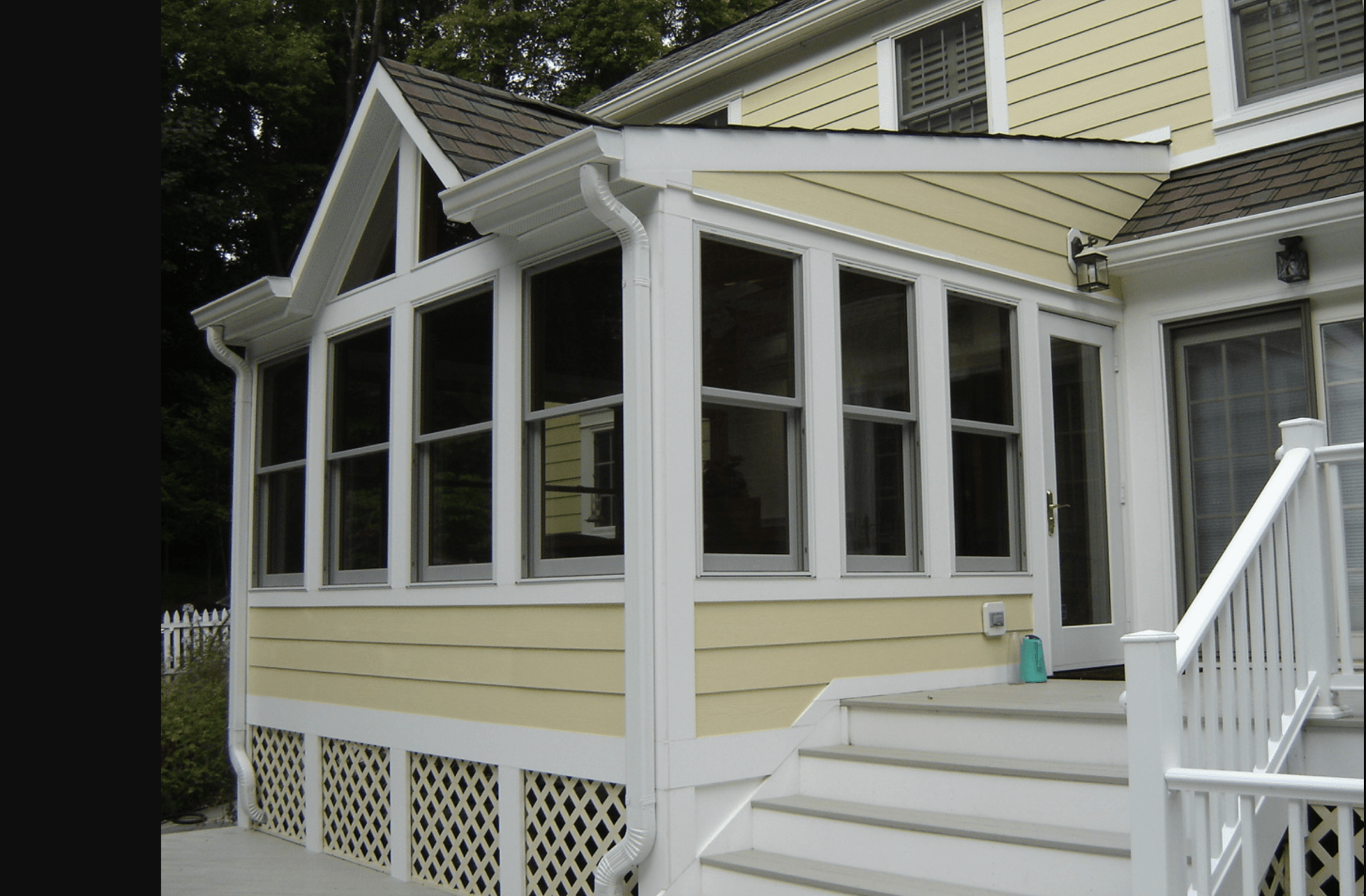 A house with a screened in porch and stairs