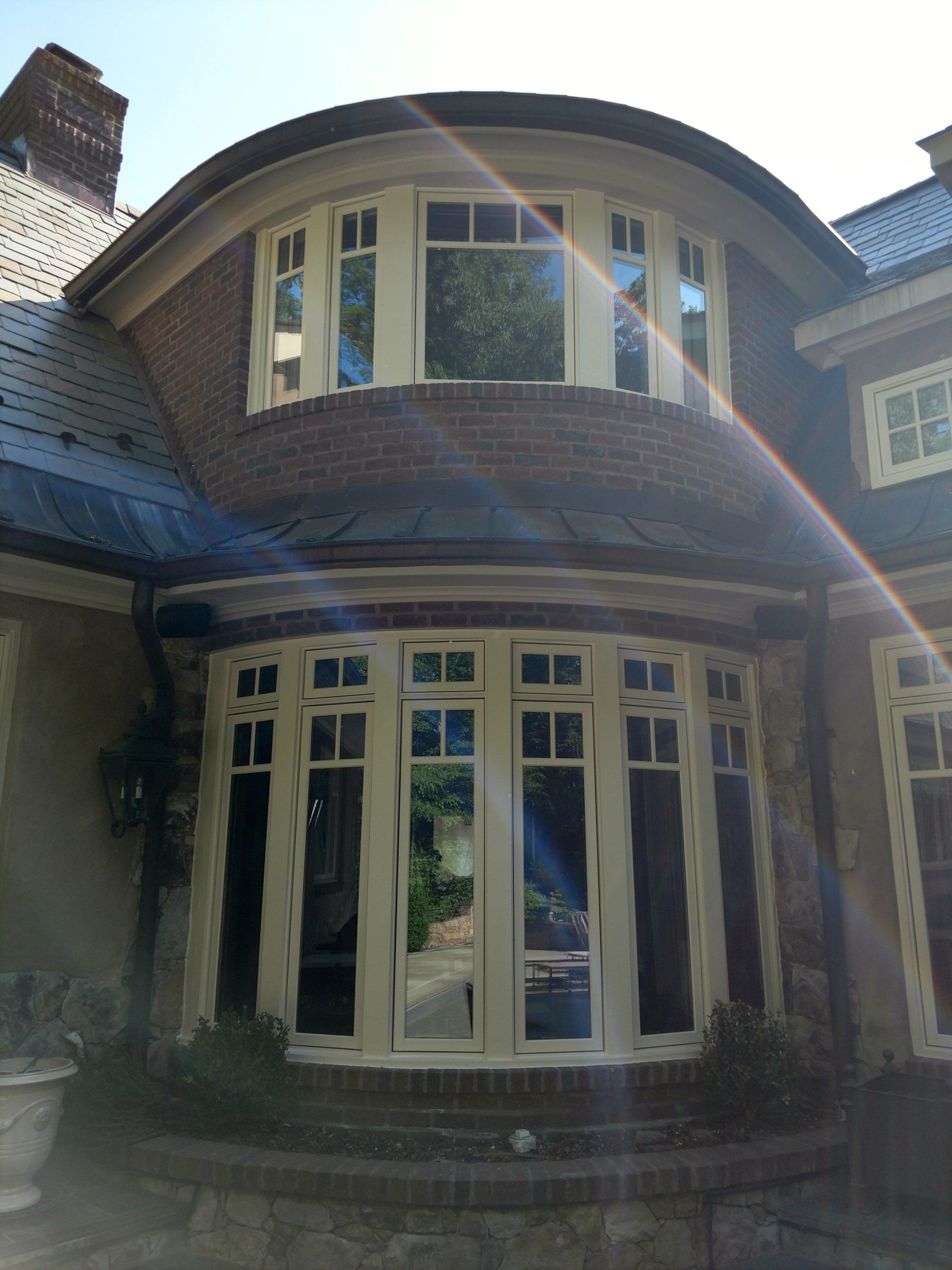 A house with a curved roof and a lot of windows