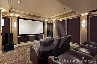 A home theater with a large screen and lots of seats
