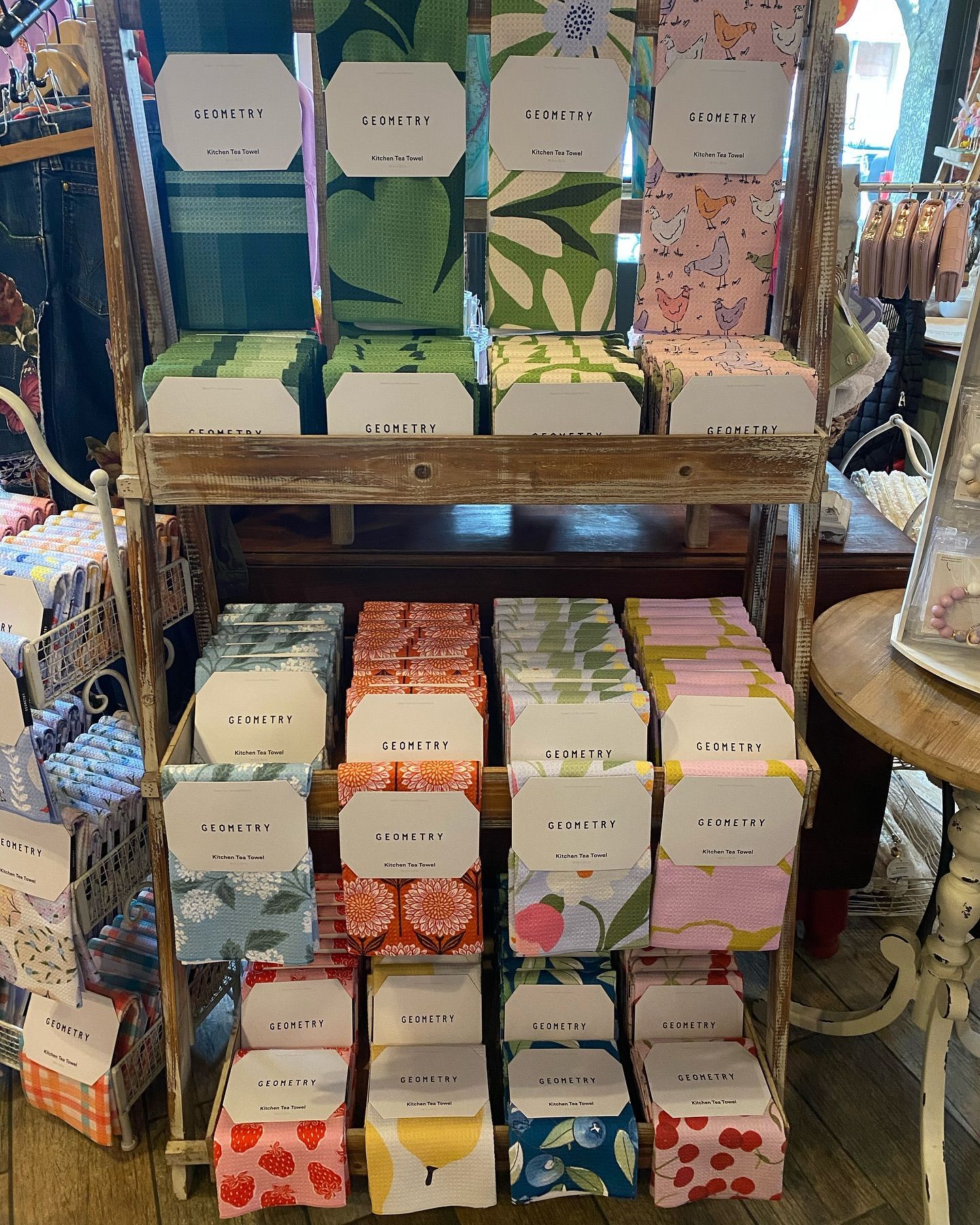 Wooden shelf display of colorful patterned boxes, possibly stationery or gifts.
