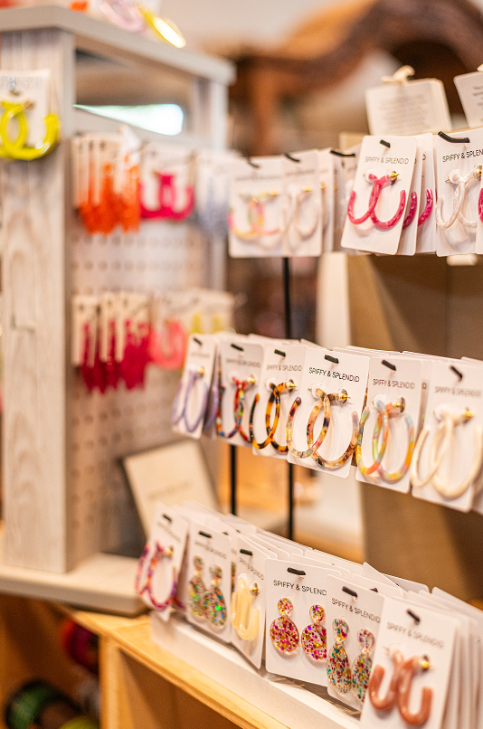 Display of colorful earrings on retail shelves.