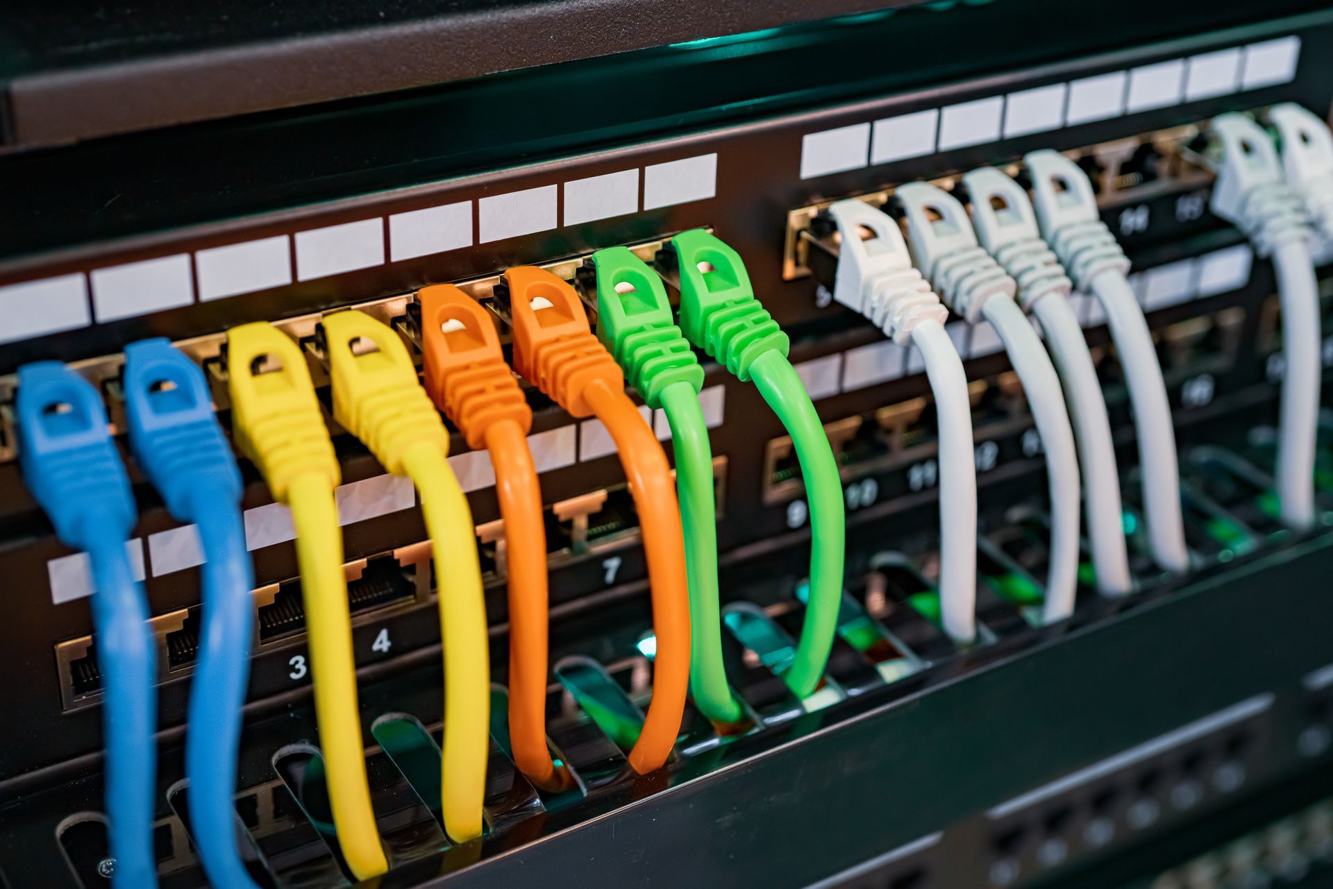 A bunch of colorful ethernet cables are connected to a server.