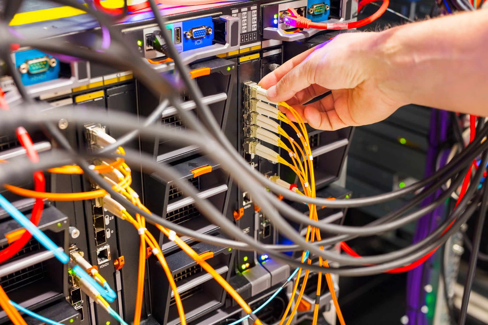 A person is working on a server in a data center.