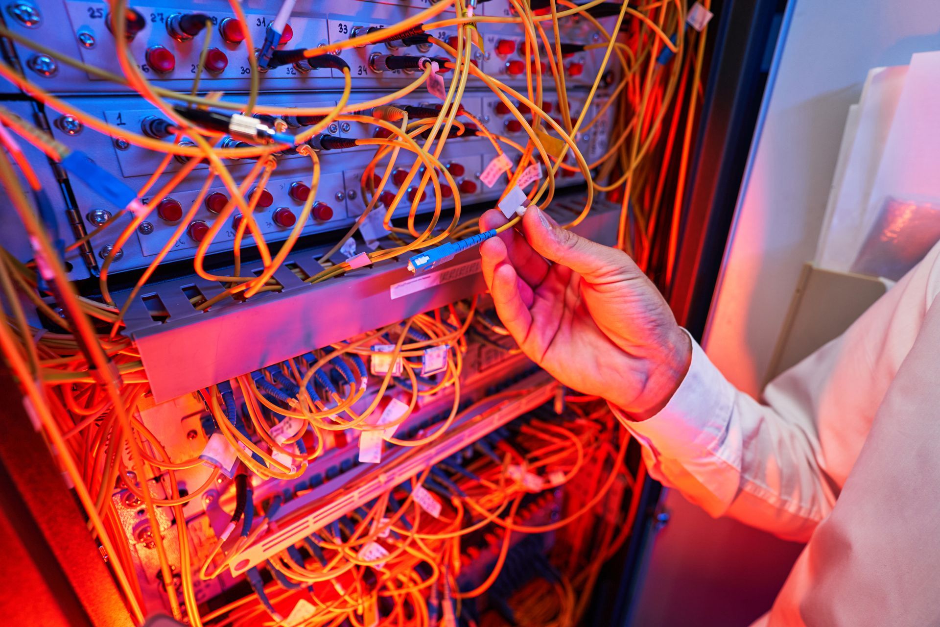 A person is working on a server in a data center.