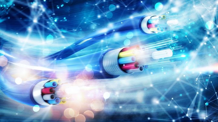 A close up of three optical fiber cables on a blue background.