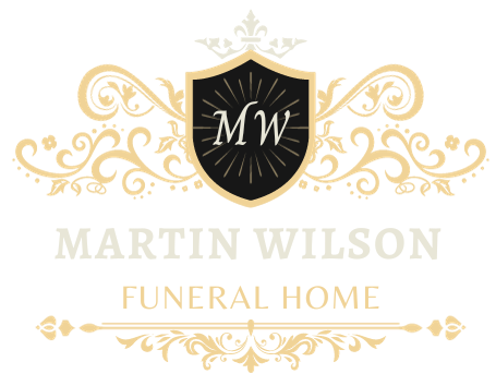 Martin Wilson Funeral Home logo. White script text on a white background.