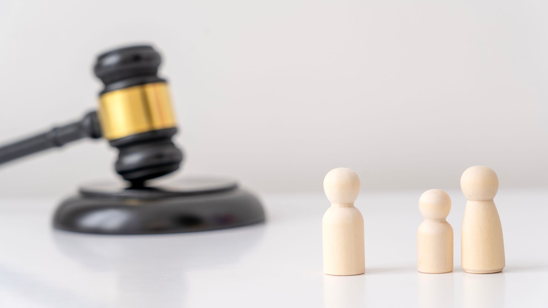 Guardianship Attorney with gavel and family figures representing legal guidance.