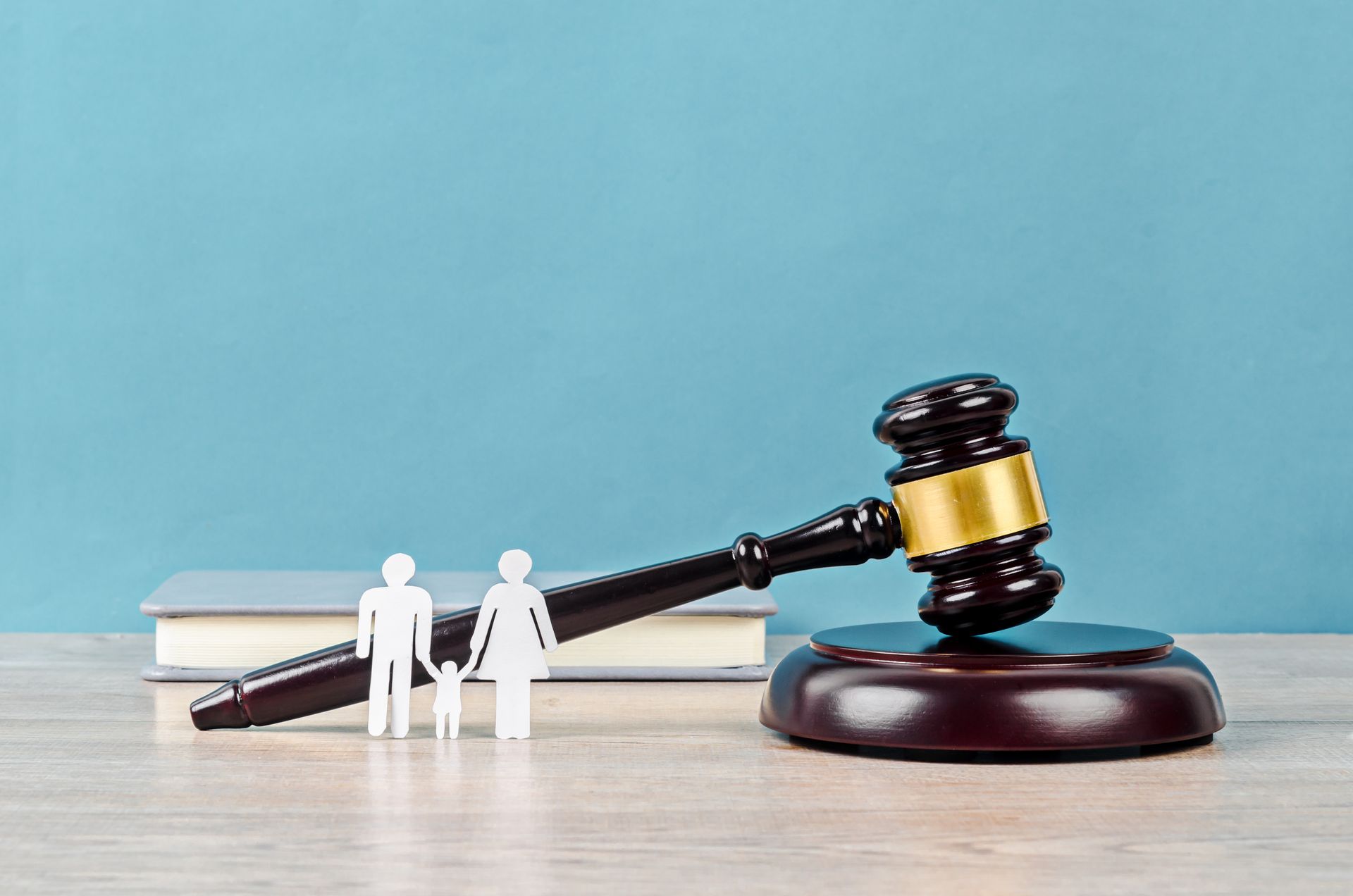 Family figure and gavel on table.