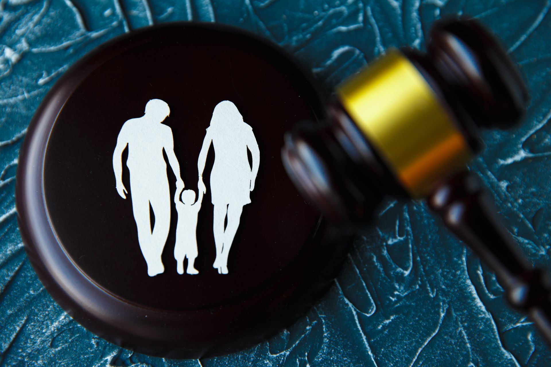 A wooden gavel with a picture of a family on it