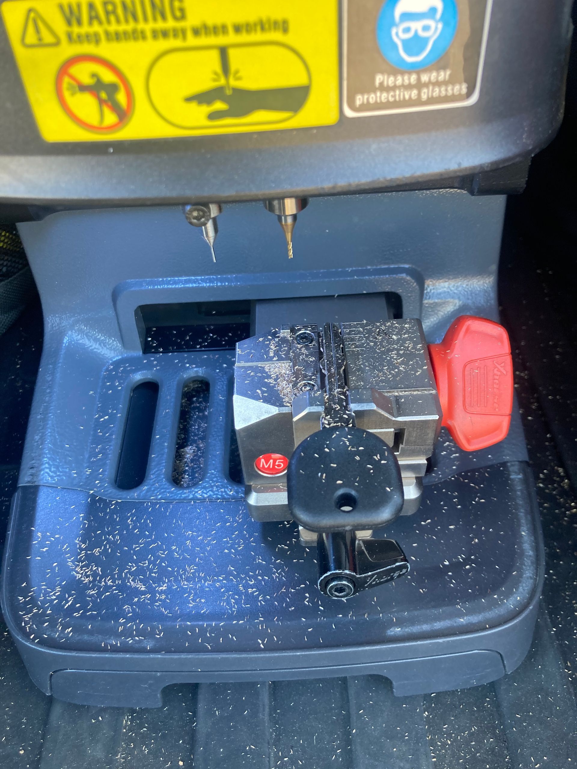 Car key cutting machine cutting a car key.