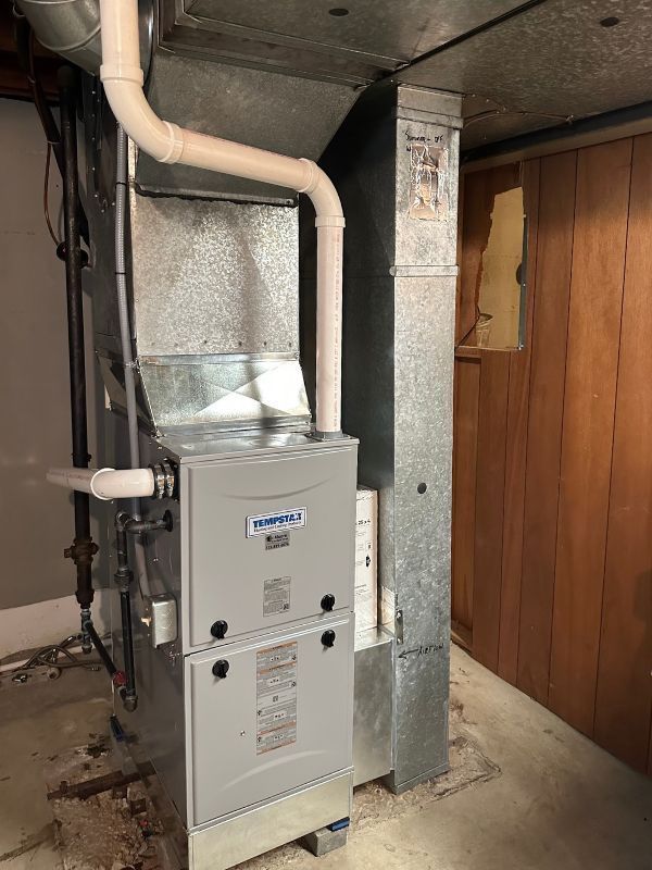 Residential Tempstar gas furnace connected to metal ductwork in a home's basement.