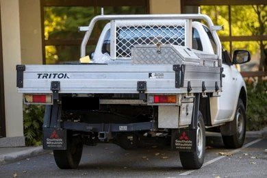 White Mitsubishi Triton utility truck with a metal tray and tool box. — Mt Isa Four Wheel Drive Services in Mount Isa City, QLD
