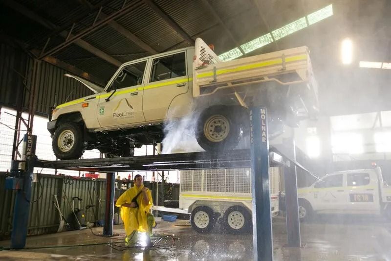 A White Truck Raised on a Lift Inside a Garage — Mt Isa Four Wheel Drive Services in Mount Isa City, QLD