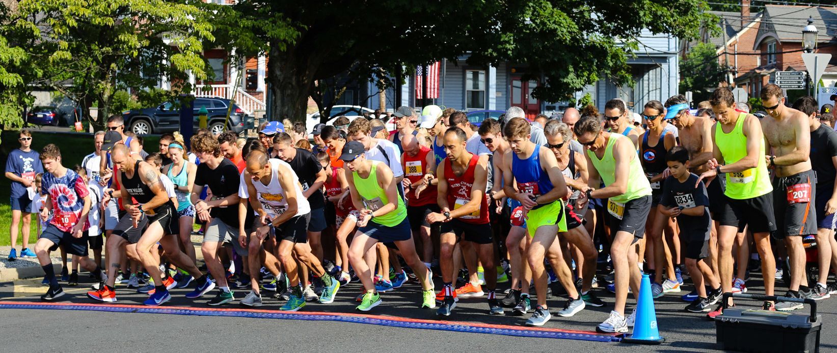 A large group of people are getting ready to run a marathon.