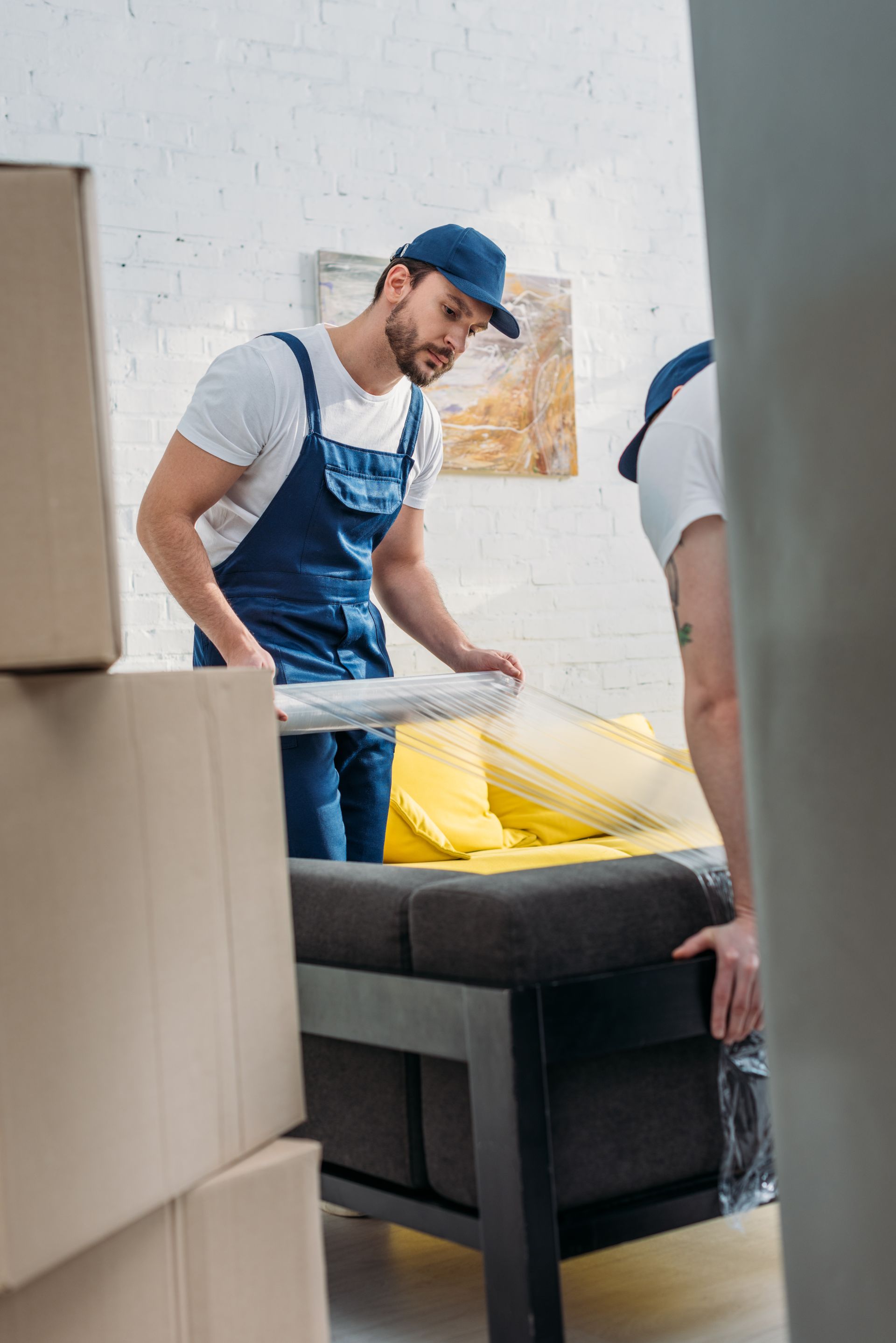 Mover wrapping furniture in a San Diego home