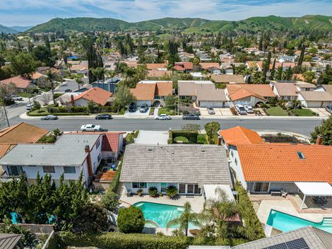 San Diego residential street with palm trees and hillside skyline