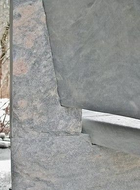 Close-up of gray stone bench.