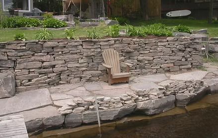 Repaired stone retaining wall after a collapse.